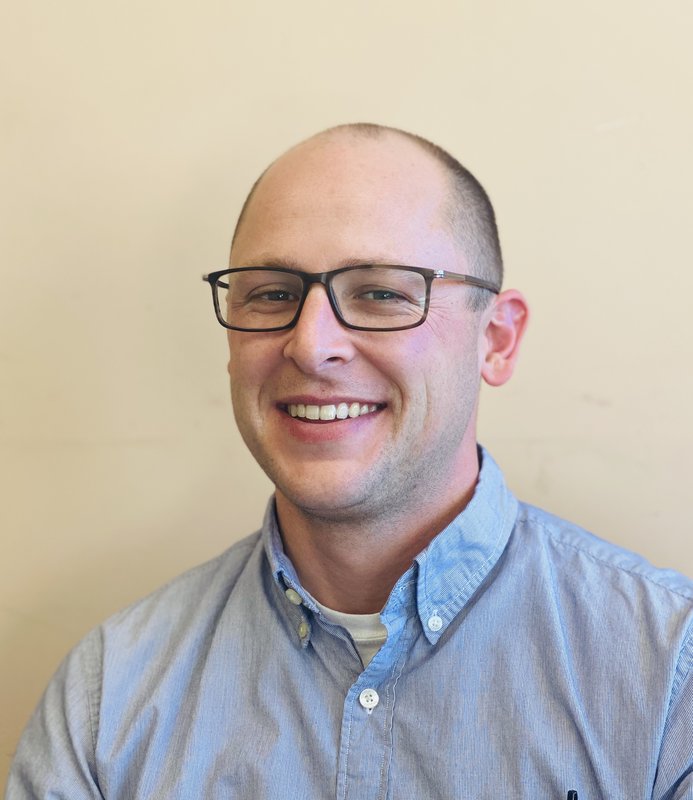 Justin Manco, CMHC, a Licensed Clinical Mental Health Counselor based in Utah, smiling headshot. Neurodivergent-affirming therapist for autism, ADHD, OCD, and PDA.